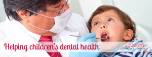 child in with dentist looking into his mouth